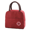 A maroon insulated lunch bag with a brown strap is shown against a white background.
