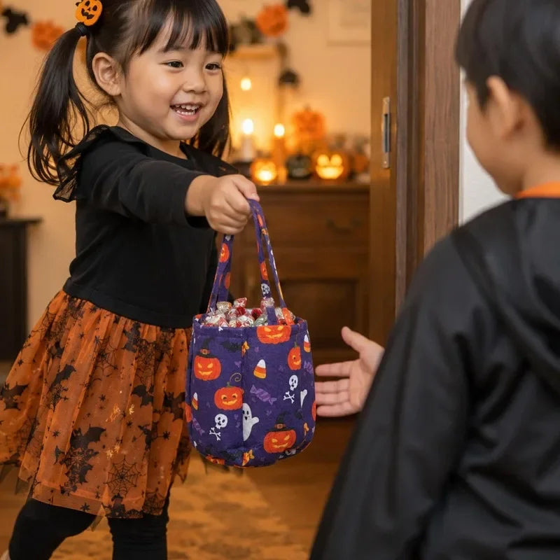 A young girl holds a purple Halloween non-woven tote bag decorated with ghost, bat, and skull designs.