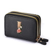Black floral letter print mini wallet with a gold zipper and leather trim