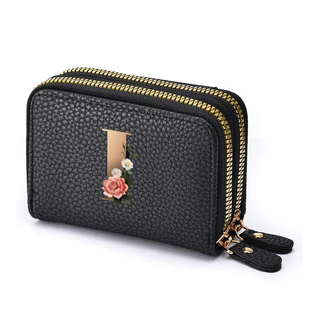 Black floral letter print mini wallet with a gold zipper and leather trim