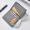 A gray slim faux leather business card wallet holding several cards and a pen.