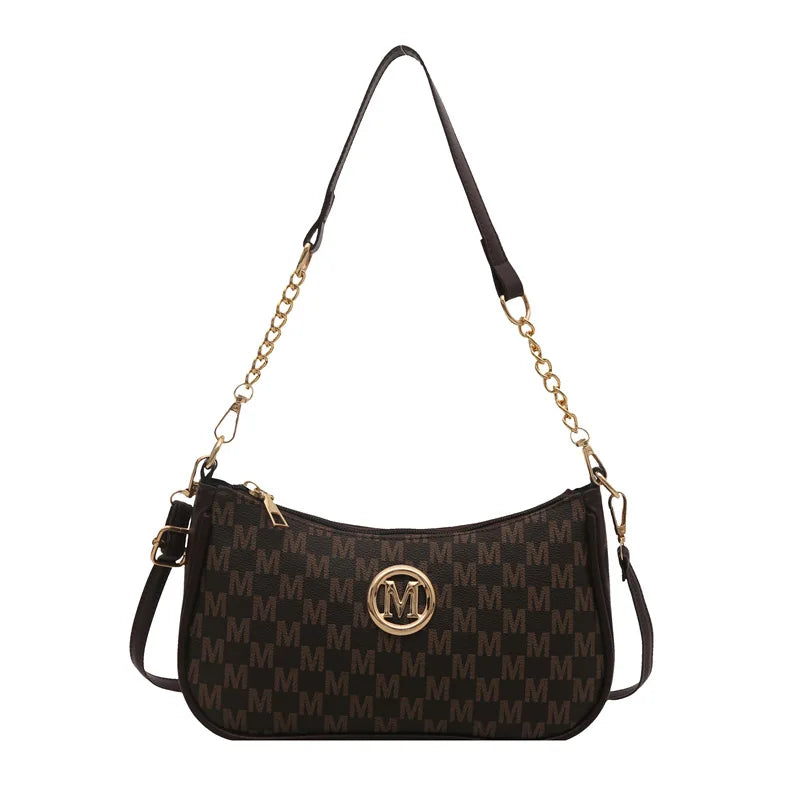 Bolso cruz negro vintage dorado con cadena dorada.