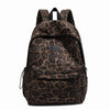 A brown leopard print laptop backpack with black padded straps.