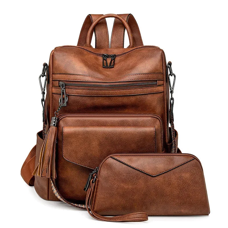 A brown retro PU leather travel backpack featuring zippered compartments and tassel details.