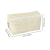 A cream-colored quilted velvet cosmetic and toiletry bag shown from the top view with dimensions.