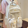 A cream-colored Kawaii Harajuku backpack with a laptop compartment is worn by a person.