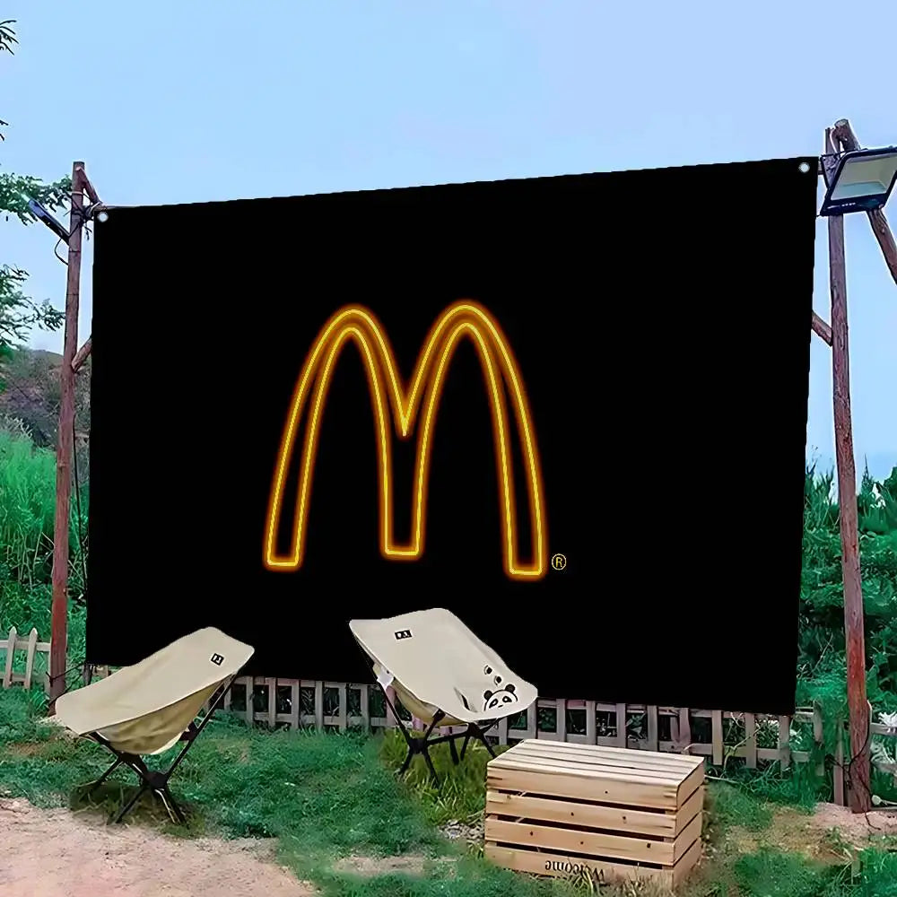 A black banner featuring a glowing yellow McDonald's 'M' logo displayed outdoors.