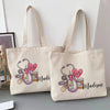 A beige canvas tote bag featuring a pink stethoscope and heart design with the name Madison printed on it.