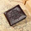 A dark brown leather wallet featuring an engraved compass design placed on an old map background.