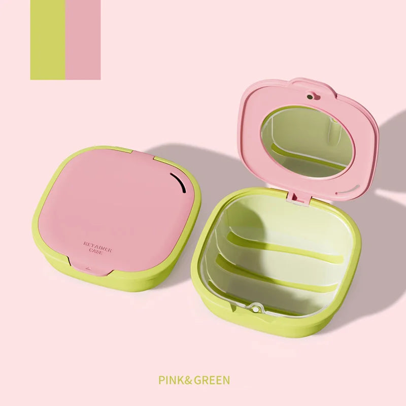Pink and green denture storage box with mirror and drainage features shown in an open and closed view.