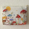 A fabric makeup bag featuring a watercolor print of various mushrooms and butterflies against a light background.