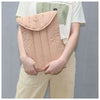 A light pink quilted cotton laptop sleeve is shown being held by a person against a gray background.