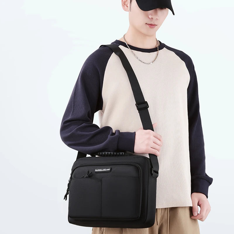 A man wearing a black cap and a beige sweater holds a black waterproof business briefcase.