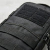 Close-up of a black tactical shoulder tool pouch with adjustable straps.