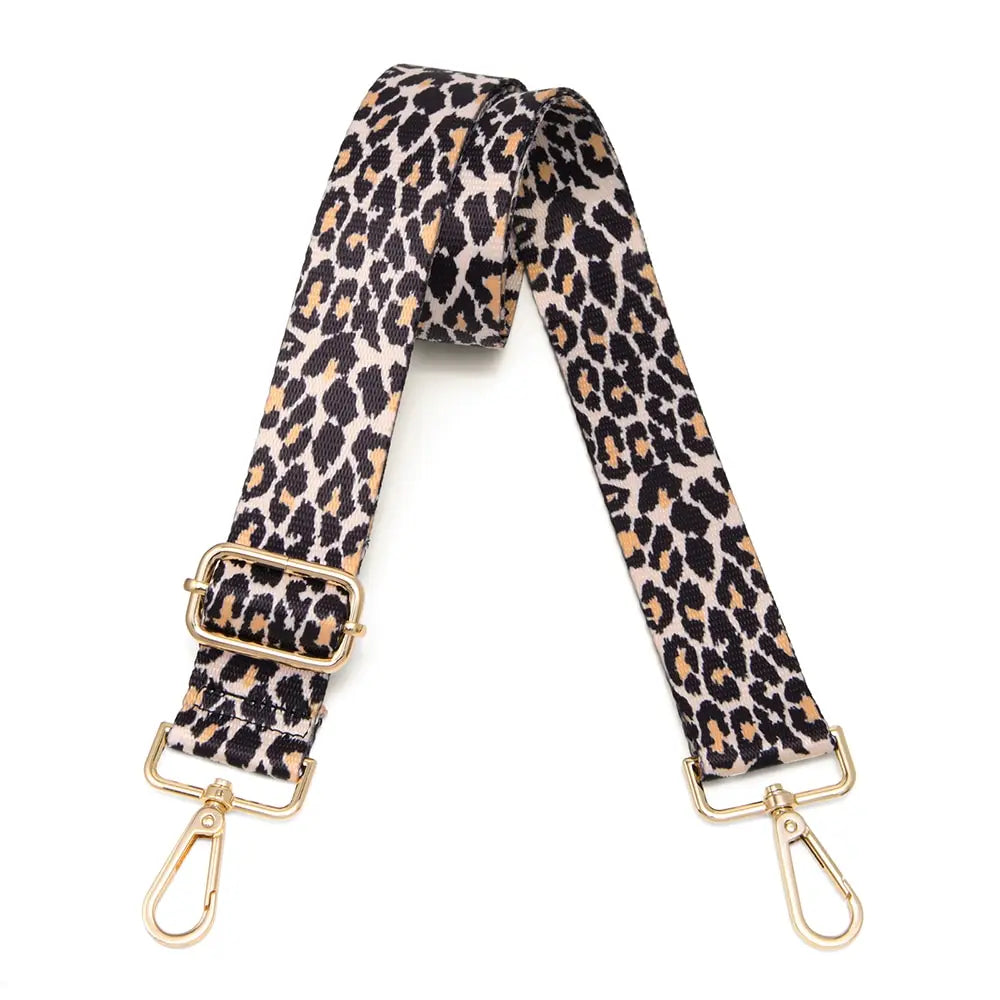A black and tan leopard print nylon crossbody bag strap.