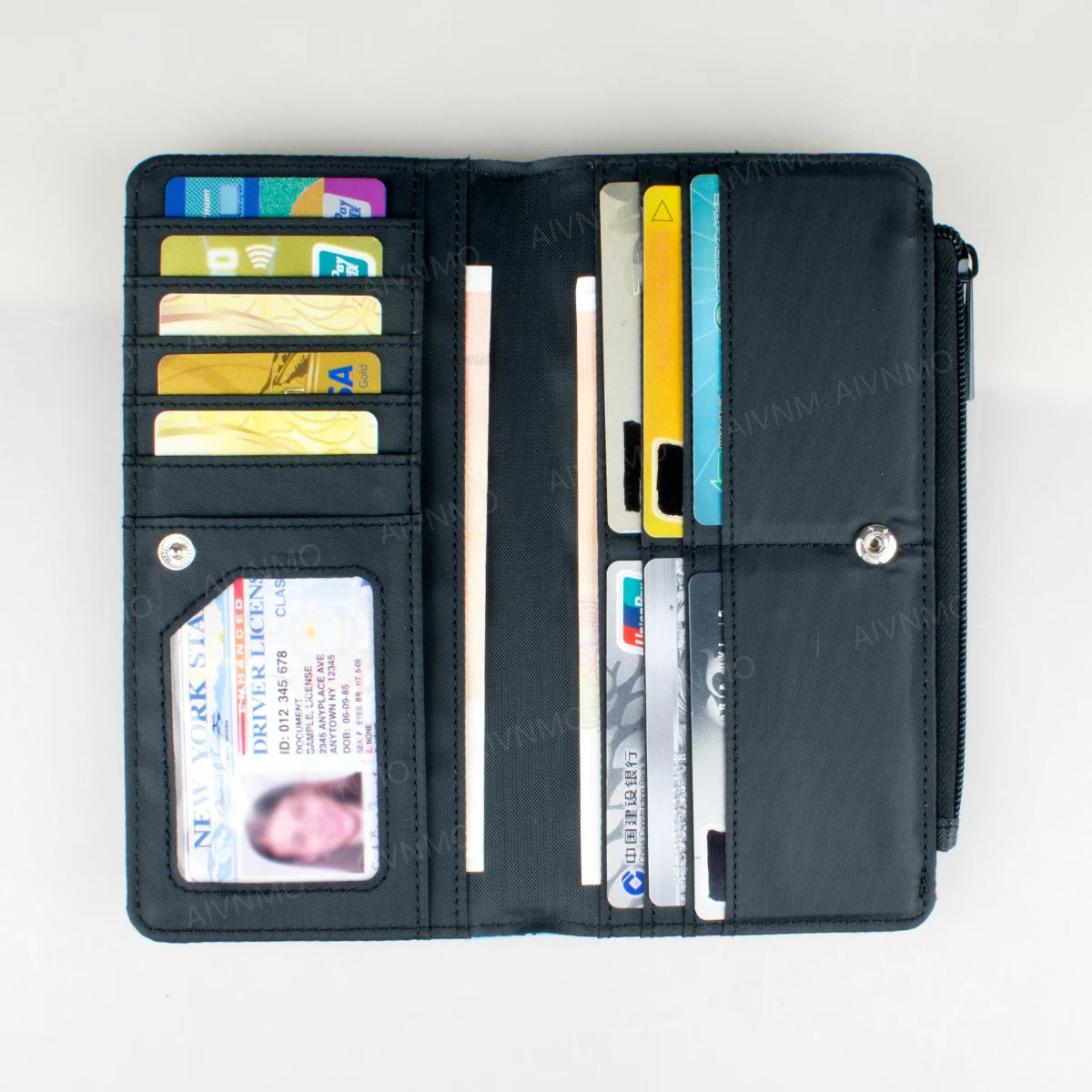 A black bi-fold wallet displaying various cards and an ID window.