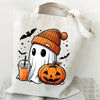 A white canvas tote bag featuring a black ghost and an orange pumpkin print with bats.
