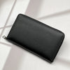 A black multi-card men's commuter wallet lying on a light surface with shadows.