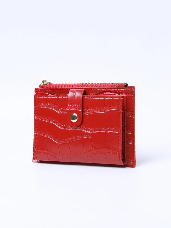 A red leather card holder with a crocodile pattern and a zipper closure.