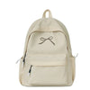 A beige nylon backpack with a drawstring closure and embroidered bow detail.