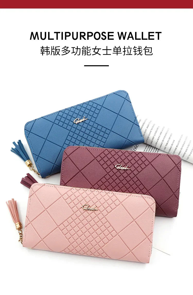 Three multipurpose women's leather wallets in blue, mauve, and pink stacked together