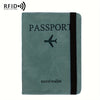 A dark teal leather passport holder with a black stripe and an airplane emblem.