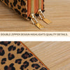 Close-up of a leopard print wallet featuring double zippers and gold hardware on a wooden surface.