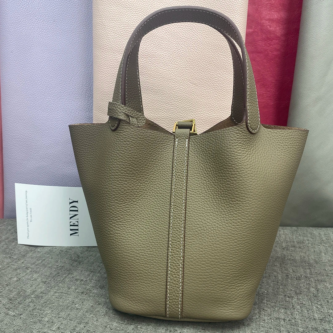 A beige classic genuine leather bucket bag displayed against a light gray background.