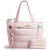A pink quilted multi-compartment tote bag with a white cup and magazines visible.