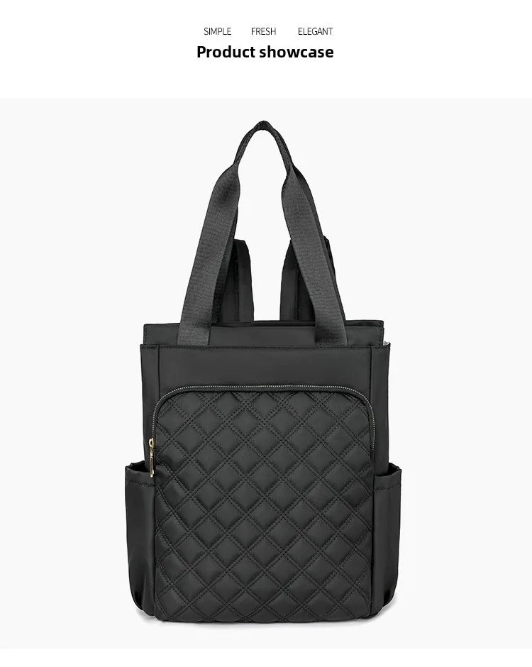 A black quilted women's backpack tote bag shown against a white background.