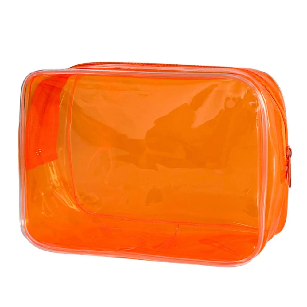 An orange transparent PVC travel makeup bag with a zipper closure.