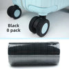 Black travel luggage wheel protectors set of 8, shown in a black plastic packaging.