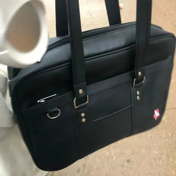 A black women's Japanese style PU shoulder bag with large capacity is shown against a light background.