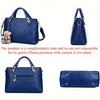 A navy blue embossed PU handbag and matching wallet set with a pendant.