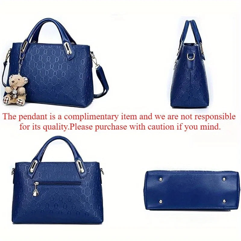 A navy blue embossed PU handbag and matching wallet set with a pendant.