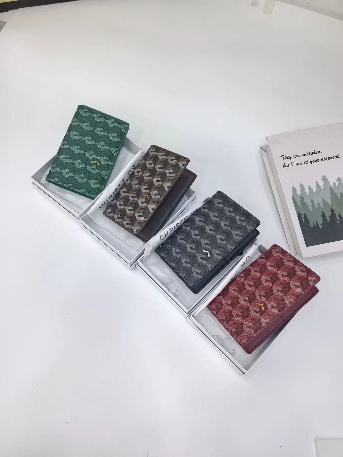 A collection of four geometric print passport wallets in shades of green, brown, and maroon displayed on a white surface.