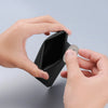A hand is opening a black magnetic foldable ID card holder to reveal a coin purse inside.