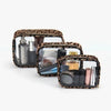 A clear cosmetic organizer bag with a leopard print exterior holding various makeup and skincare products.