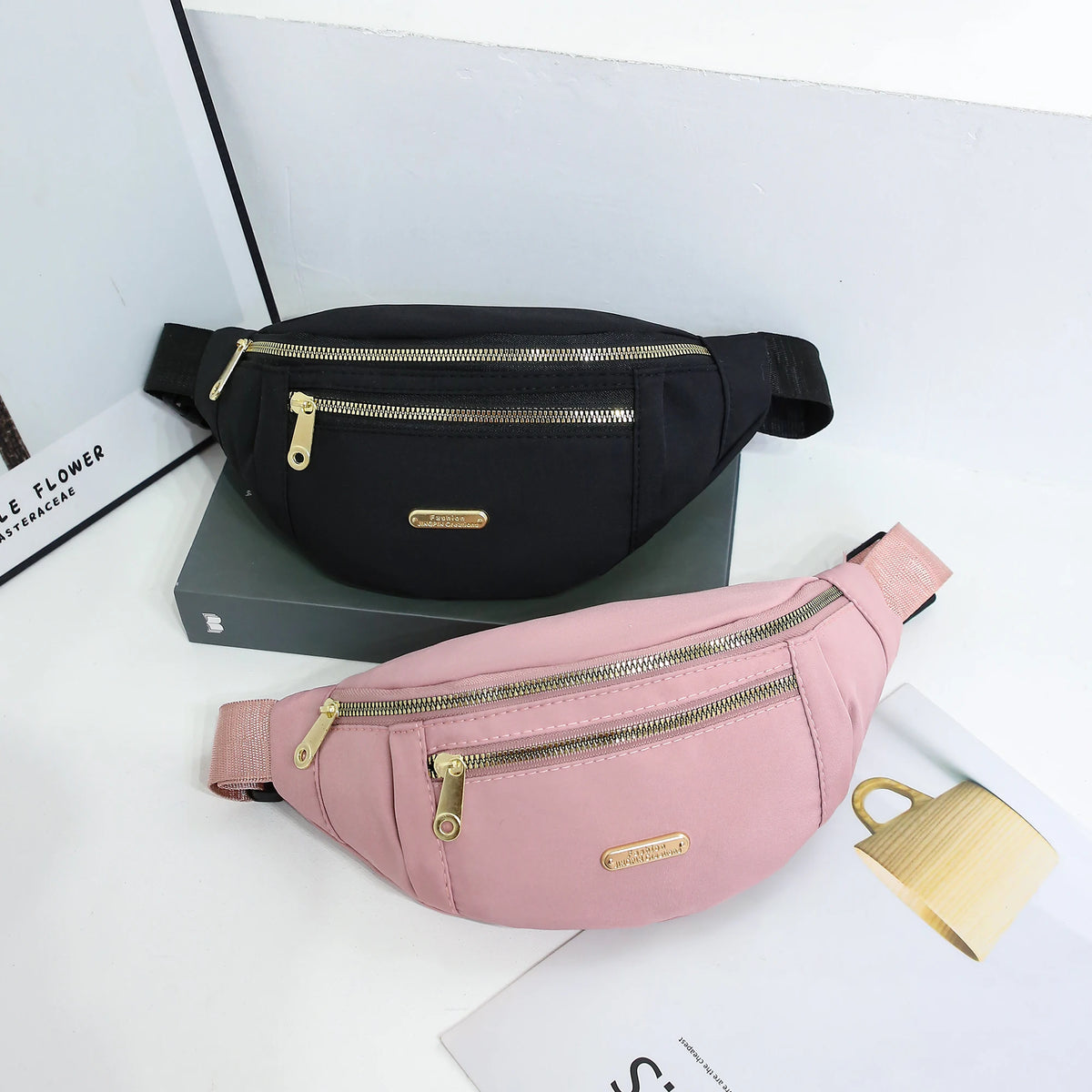 A pink lightweight nylon crossbody fanny pack is displayed on a white surface.