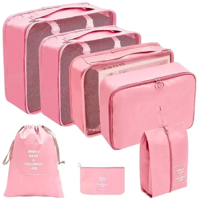 A set of pink fabric storage organizers including a large box and several smaller pouches.