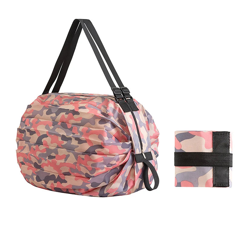 A foldable nylon storage bag in a camouflage pattern with black straps and handle.