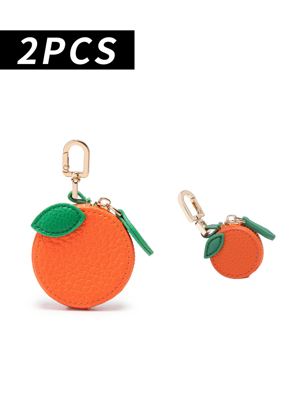 Two orange cherry fruit shape coin purse keychains with green fabric and gold-tone hardware.