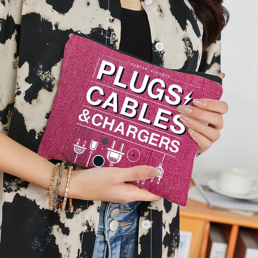 A hand holds a magenta zippered organizer pouch for plugs, cables, and chargers against a person wearing a black and white pa