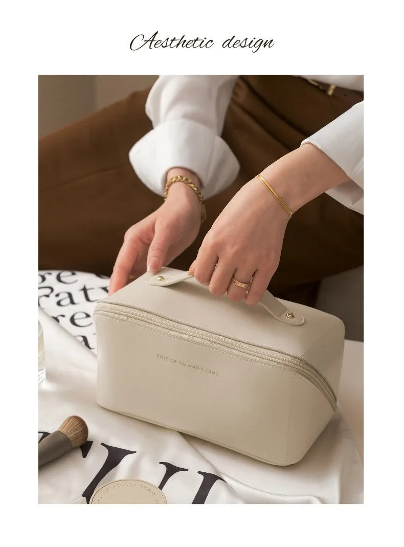 A beige foldable cosmetic storage bag being held by a person in a soft, natural light setting.