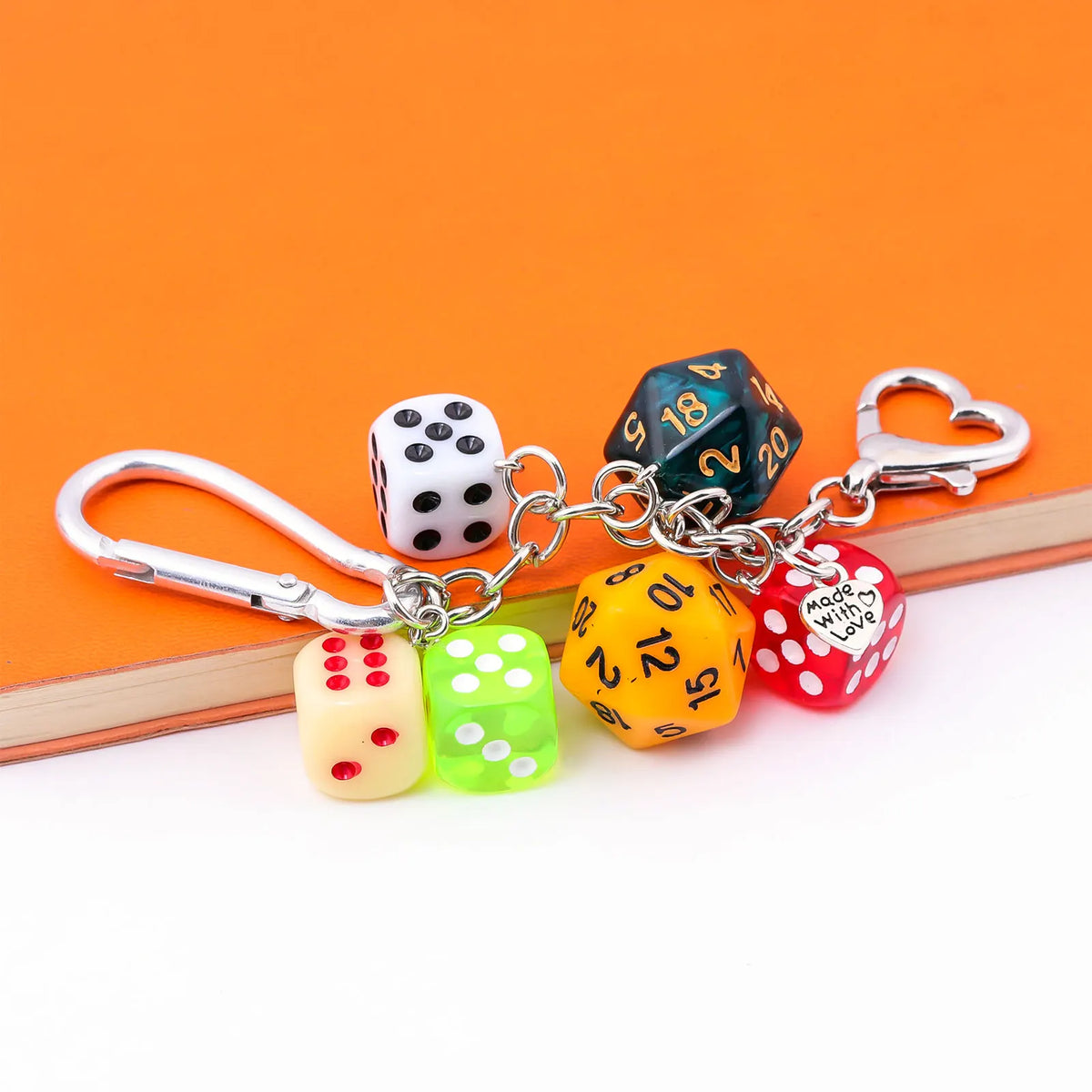 A set of colorful dice charms in various colors are attached to a silver keychain.