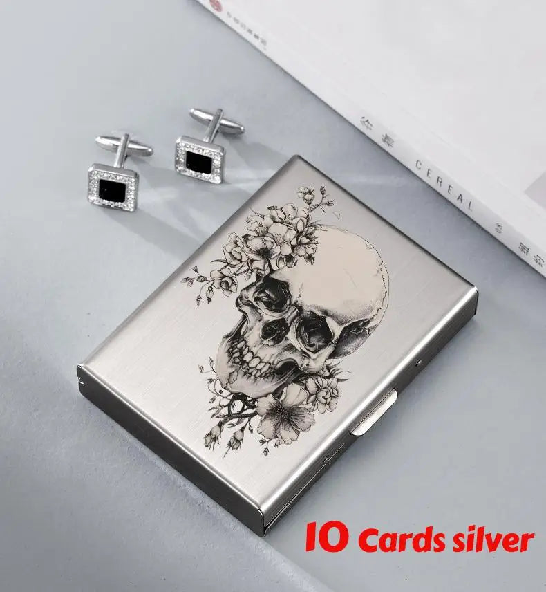 Silver slim card holder wallet featuring a detailed skull design and diamond-encrusted pins.