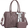 A mauve PU leather laptop tote bag with a floral pattern, featuring a matching scarf and a small clutch.
