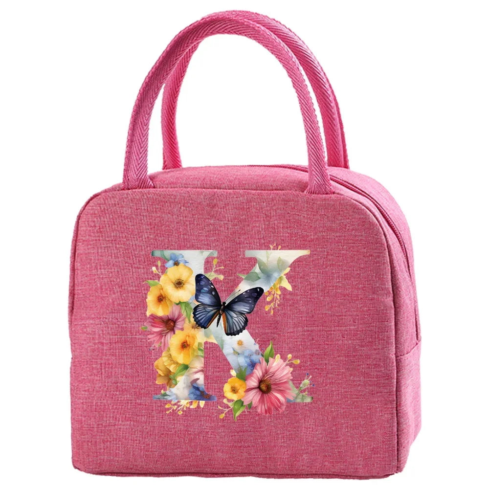 A pink insulated canvas lunch bag with a handle featuring a butterfly and floral embroidery.