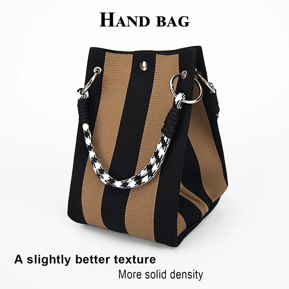 A hand bag featuring black and tan stripes with a white patterned strap.