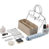 A multi-pocket felt bag organizer insert with various cosmetic and small items displayed alongside the bag.